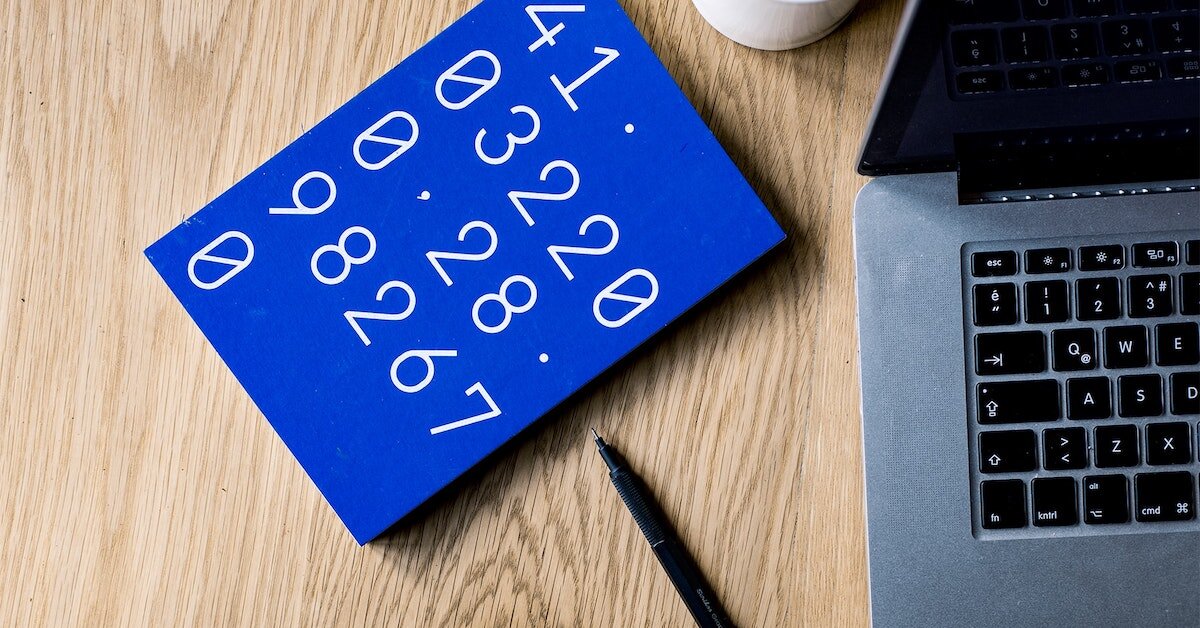 A notebook of rent figures next to a laptop and pen A notebook of rent figures next to a laptop and pen